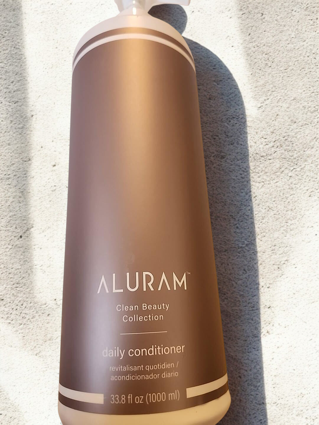 Alurum Conditioner bottle showing product consistency and texture